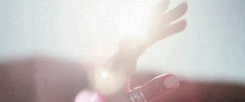 A Close Up Of A Person 'S Hand Holding A Bottle Of Water . GIF