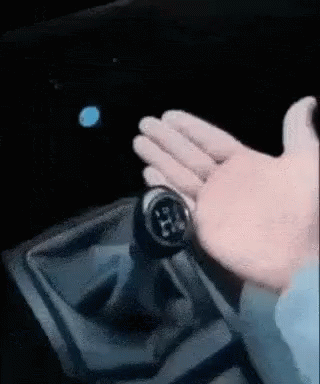 A Close Up Of A Person 'S Hand Holding A Gear Shifter GIF