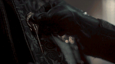 a close up of a person 's hand holding a key