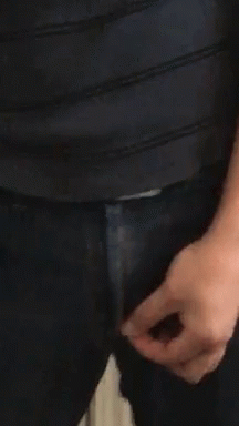 A Close Up Of A Person 'S Hand Holding A Zipper On A Pair Of Jeans GIF