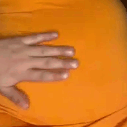 A Close Up Of A Person 'S Hand On A Yellow Item . GIF
