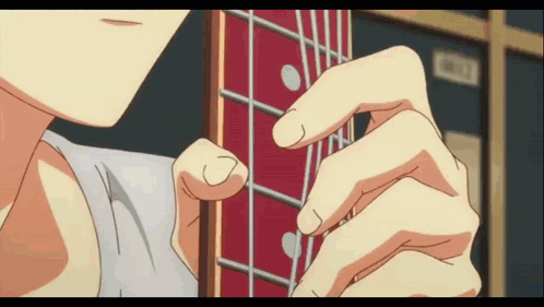 A Close Up Of A Person 'S Hand Playing A Guitar GIF