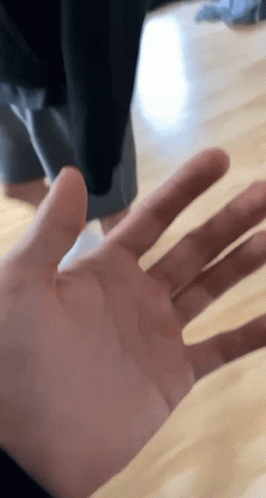 A Close Up Of A Person 'S Hand Reaching Out Towards The Camera GIF