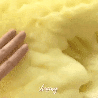 A Close Up Of A Person 'S Hand Touching A Yellow Blanket . GIF