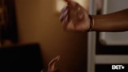 A Close Up Of A Person 'S Hand With A Bet Logo Below It GIF