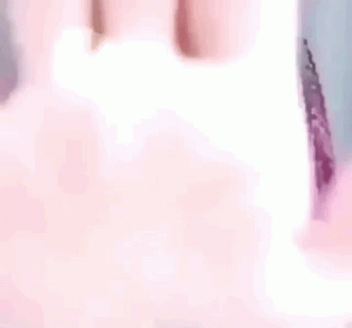 A Close Up Of A Person 'S Hand With A Blurred Background GIF