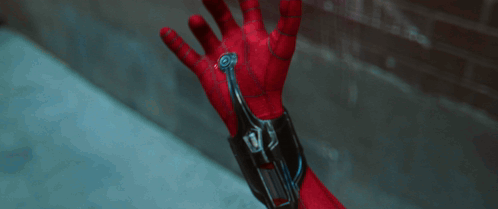 A Close Up Of A Person 'S Hand With A Device On It That Says ' Spiderman ' On It GIF