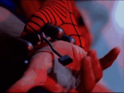 A Close Up Of A Person 'S Hand With A Red Spider Web On It GIF