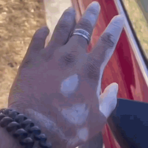 A Close Up Of A Person 'S Hand With A Ring On It . GIF