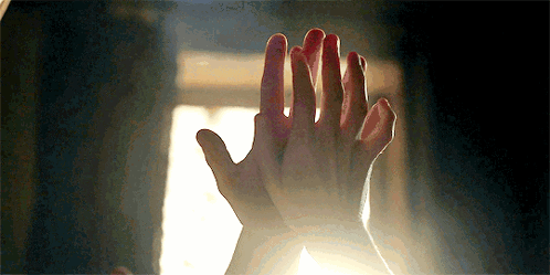 A Close Up Of A Person 'S Hands Giving Each Other A High Five In Front Of A Window . GIF