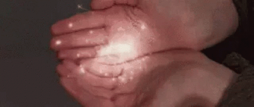 a close up of a person 's hands holding something in their hands .