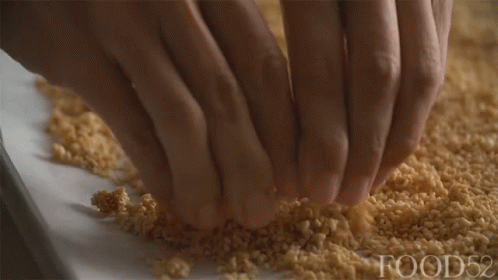 A Close Up Of A Person 'S Hands On A Pile Of Food52 GIF