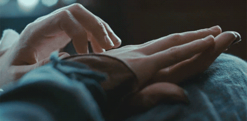 A Close Up Of A Person 'S Hands Touching Another Person 'S Hand GIF