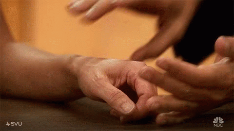 A Close Up Of A Person 'S Hands Touching Each Other . GIF