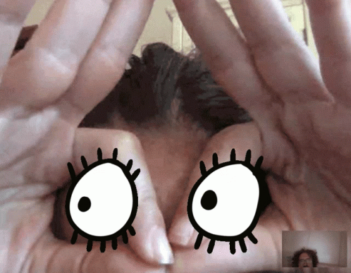 A Close Up Of A Person 'S Hands With A Cartoon Eye Drawn On Them GIF