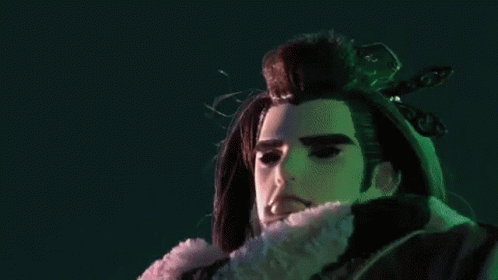 A Close Up Of A Person 'S Hands With A Purple Object Between Them GIF
