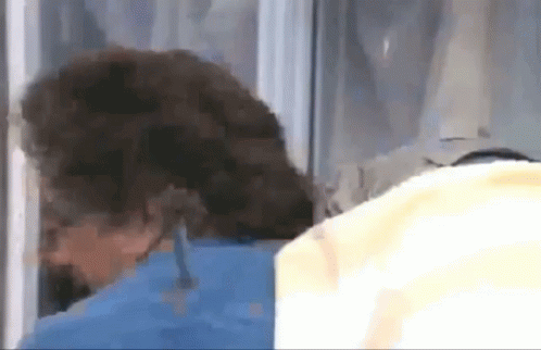 A Close Up Of A Person 'S Head Behind A Glass Door GIF