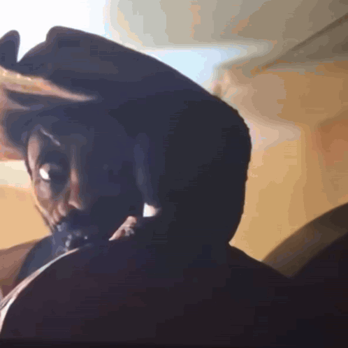 A Close Up Of A Person 'S Head With A Hat On GIF