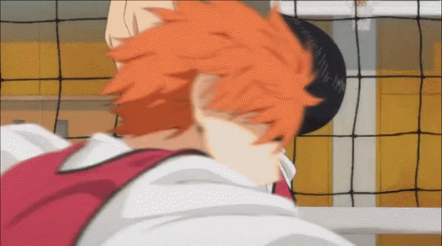 A Close Up Of A Person 'S Head With Orange Hair In Front Of A Volleyball Net GIF