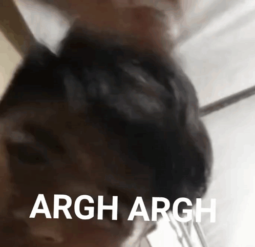 A Close Up Of A Person 'S Head With The Words Argh Argh Written In White Letters . GIF