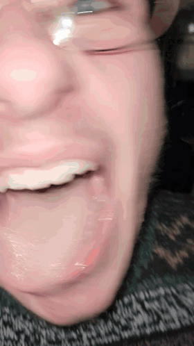 A Close Up Of A Person 'S Mouth With Glasses GIF