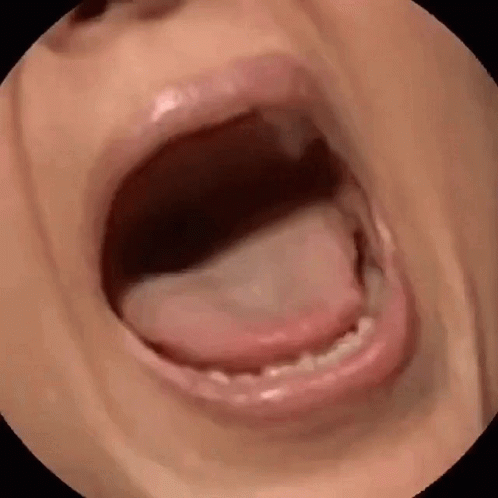 A Close Up Of A Person 'S Mouth With Their Tongue Sticking Out GIF