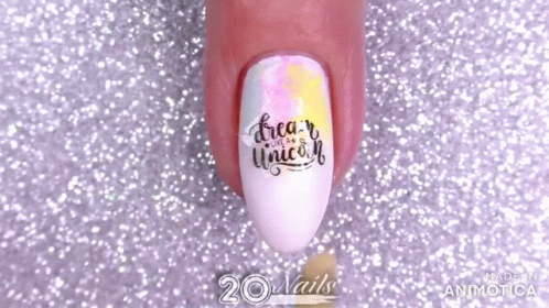 A Close Up Of A Person 'S Nails With The Words `` Dream Like A Unicorn '' Painted On Them . GIF