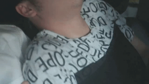 A Close Up Of A Person 'S Neck With A Shirt That Says ' Ec Ope ' On It GIF