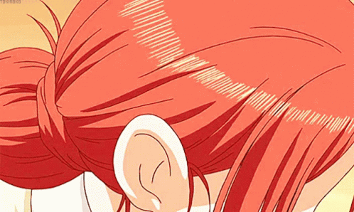 a close up of a person 's red hair and ear .