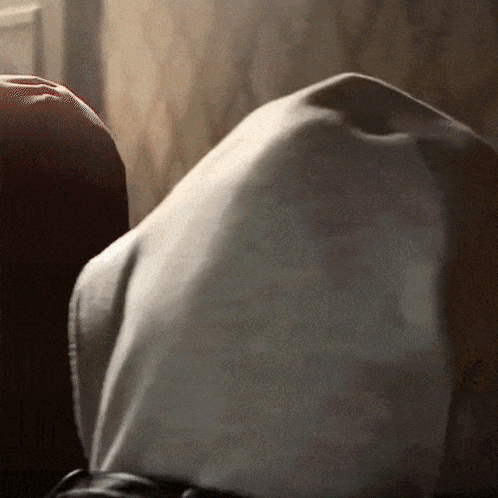 A Close Up Of A Person 'S Torso With A White Shirt On GIF