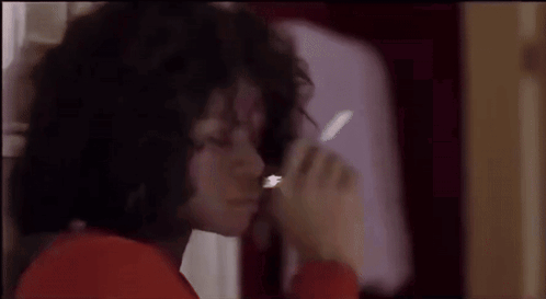 A Close Up Of A Person Smoking A Cigarette In A Bathroom . GIF