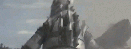 a close up of a person standing in the middle of a field with smoke coming out of their mouth .