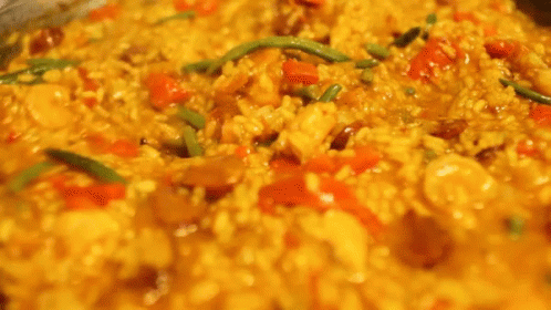 A Close Up Of A Person Stirring A Pot Of Food With A Fork . GIF