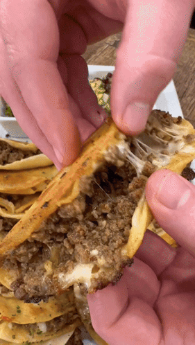 A Close Up Of A Person Taking A Piece Of Food Out Of A Plate GIF