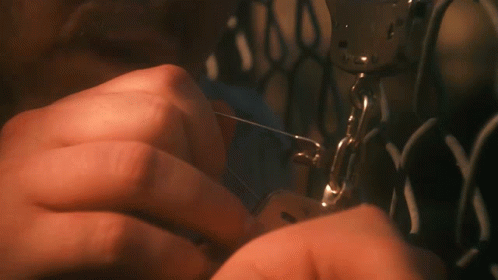 A Close Up Of A Person Using A Sewing Machine With The Letter N On It GIF