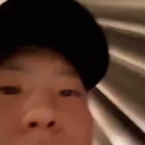 A Close Up Of A Person Wearing A Black Hat . GIF