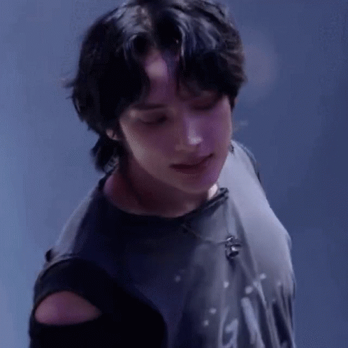 A Close Up Of A Person Wearing A Black Shirt With A Microphone On It . GIF