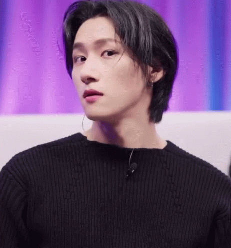 A Close Up Of A Person Wearing A Black Sweater And A Microphone GIF