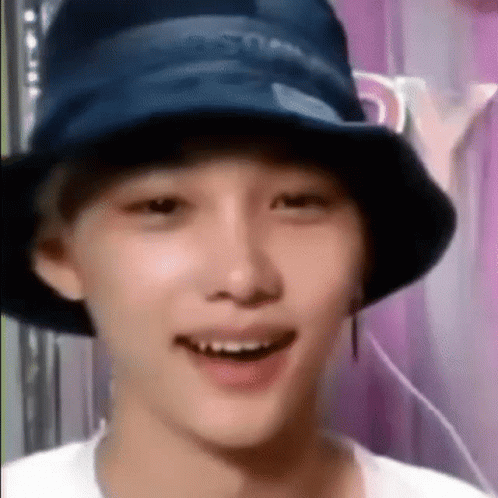 A Close Up Of A Person Wearing A Bucket Hat . GIF