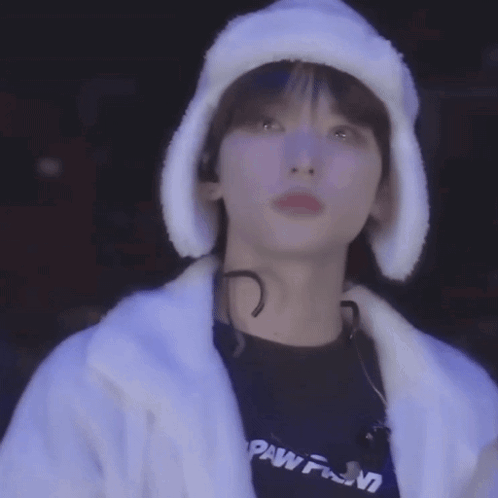 A Close Up Of A Person Wearing A Fur Hat And A White Coat . GIF