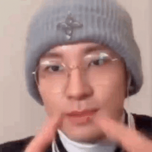 A Close Up Of A Person Wearing A Hat And Glasses . GIF