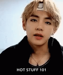 A Close Up Of A Person Wearing A Headband And A Necklace With The Words `` Hot Stuff 101 '' . GIF