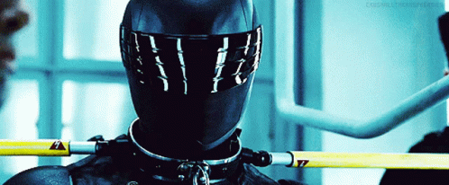 A Close Up Of A Person Wearing A Helmet And A Collar With A Yellow Warning Sign GIF