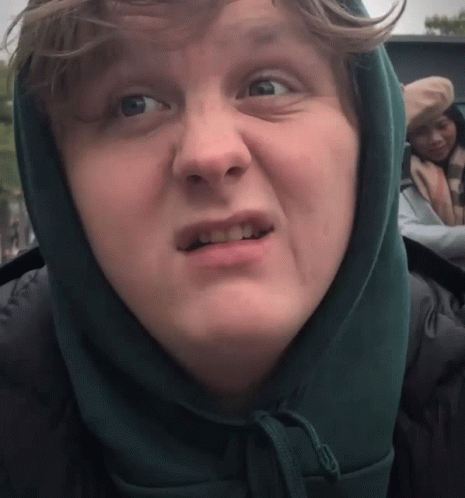 A Close Up Of A Person Wearing A Hooded Jacket GIF
