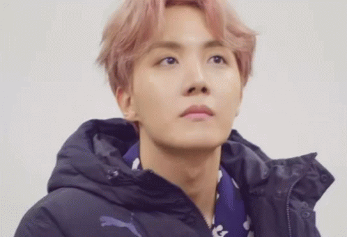 A Close Up Of A Person Wearing A Hoodie And A Scarf . GIF
