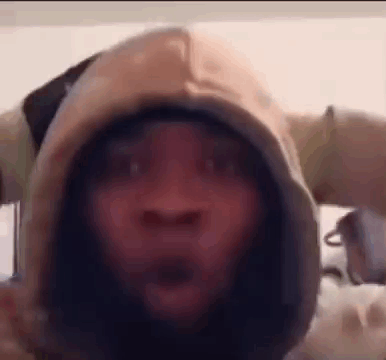A Close Up Of A Person Wearing A Hoodie With A Surprised Look On Their Face . GIF