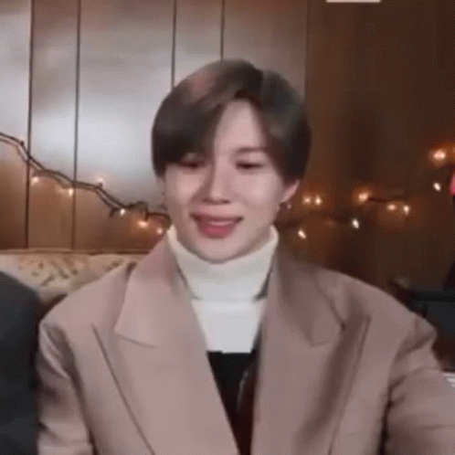 A Close Up Of A Person Wearing A Jacket And A White Turtleneck . GIF