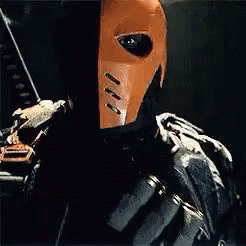 A Close Up Of A Person Wearing A Mask And Holding A Bow And Arrow . GIF