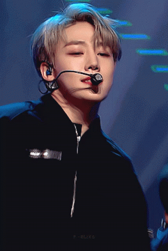 A Close Up Of A Person Wearing A Microphone And A Black Shirt GIF