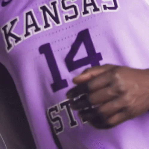 A Close Up Of A Person Wearing A Purple Basketball Jersey With The Number 14 On It . GIF